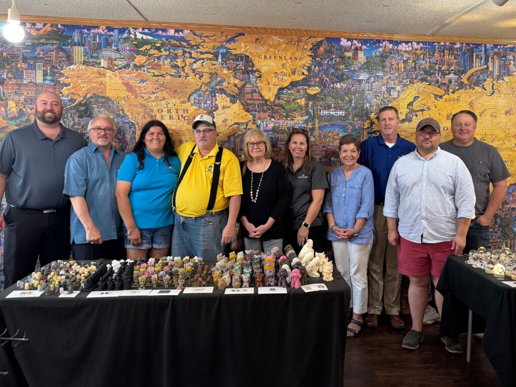 Rotary July 15_4658 The Casey Rotary Club toured the Rock Shop on Main Street in downtown Casey on Tuesday, following a presentation by owner Jeff Winnett at Tuesday’s Rotary Club meeting at Richards Farm. Pictured (l to r) in front of the World’s Largest Jigsaw Puzzle are Chris Snedeker, Jay Marwell, Teresa Winnett, Jeff Winnett, Marcy Mumford, Megan Peavler, Sharon Durham, Kurt Squires, Tom Daughhetee, and Brian Hancock.