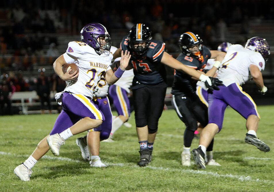 Casey-Westfield's Gio Santillan powers through the Paris defense for a gain. Santillan recorded two key first downs on the ground during a Warrior drive in the third quarter. —photo by Terri Cox