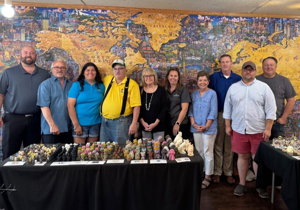 Rotary July 15_4658 The Casey Rotary Club toured the Rock Shop on Main Street in downtown Casey on Tuesday, following a presentation by owner Jeff Winnett at Tuesday’s Rotary Club meeting at Richards Farm. Pictured (l to r) in front of the World’s Largest Jigsaw Puzzle are Chris Snedeker, Jay Marwell, Teresa Winnett, Jeff Winnett, Marcy Mumford, Megan Peavler, Sharon Durham, Kurt Squires, Tom Daughhetee, and Brian Hancock.